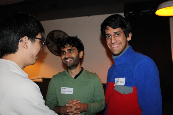 Students speaking with each other and smiling
